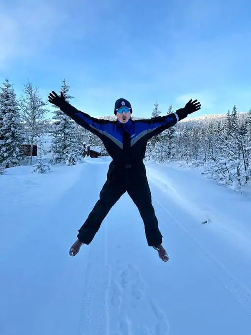 The same jump a second earlier: he is lower in the frame and his arms are less extended, but the scene is otherwise identical.